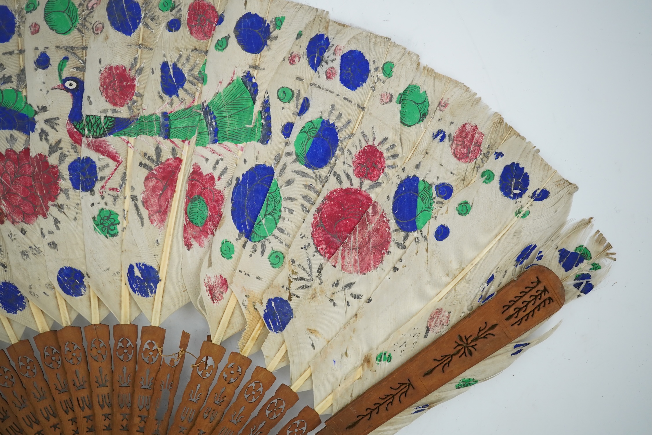 Three 19th century Chinese feather fans: One a carved bone brise black feather fan together with two similar carved sandalwood feather fans, two fans have hand painted decoration on the feathers both sides, the pink feat